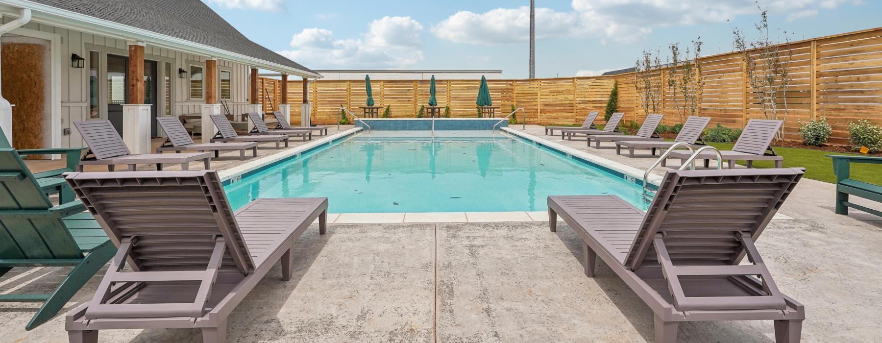 a pool with chairs around it