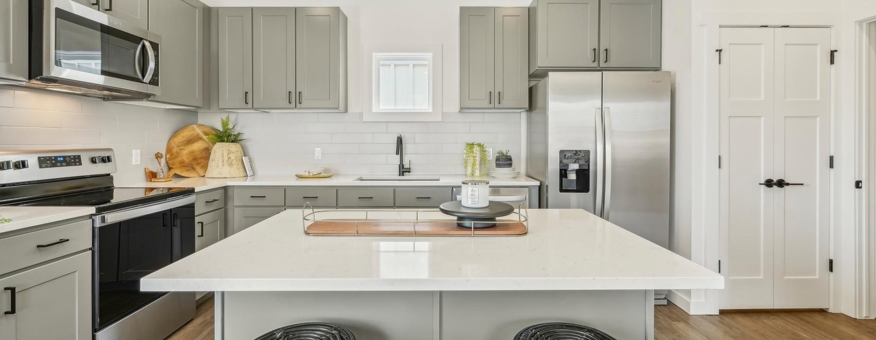 a kitchen with white cabinets