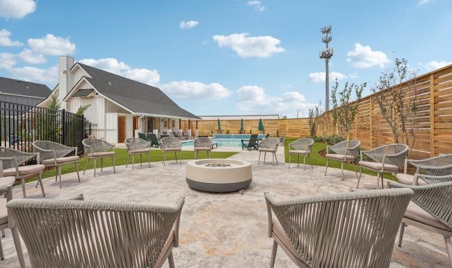 Take advantage of all Magnolia Row has to offer a patio with chairs and tables and fire pit in the middle