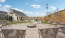 a patio with chairs and tables and fire pit in the middle