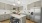 a kitchen with a fridge and stools