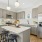 a kitchen with a fridge and stools