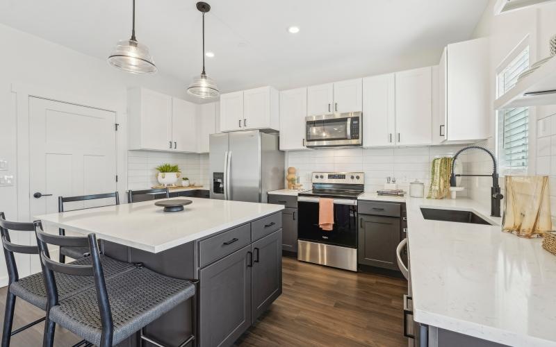 a kitchen with grey cabinets