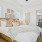 a bedroom with a bed and lamps
