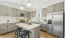 a kitchen with a fridge and stools