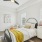 a bedroom with a bed and a fan