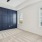 a room with a blue wall and a ceiling fan
